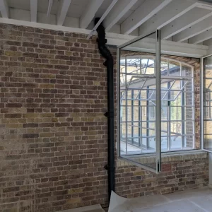 Exposed Brick and Drain Pipe in London Office
