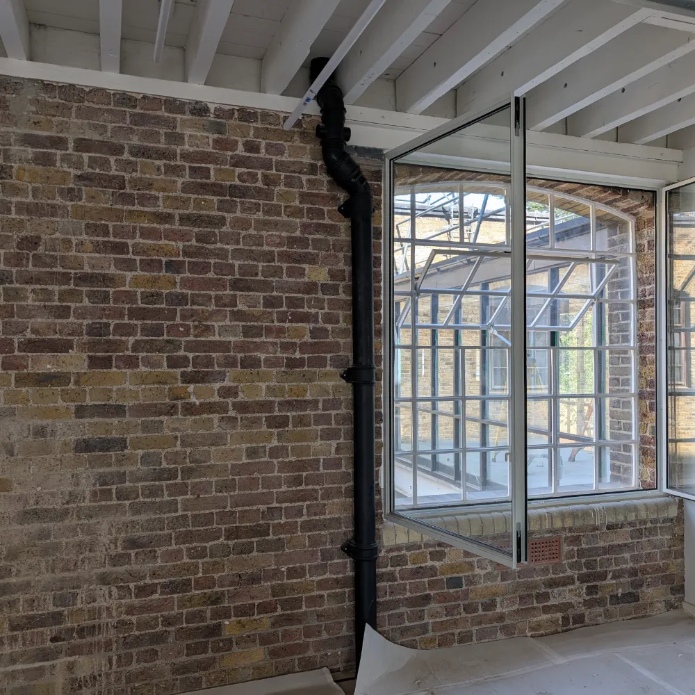 Exposed Brick and Drain Pipe in London Office